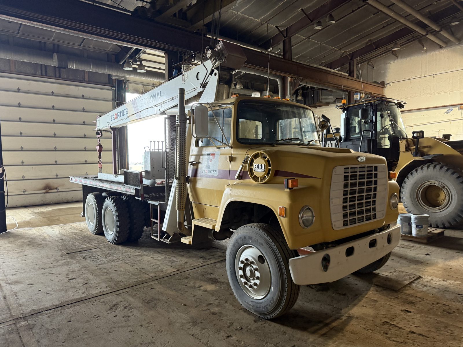 Frontier boom truck and CAT wheel loader