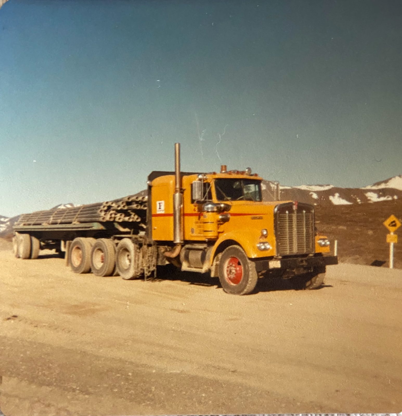 Classic Frontier haul truck with a pipe load